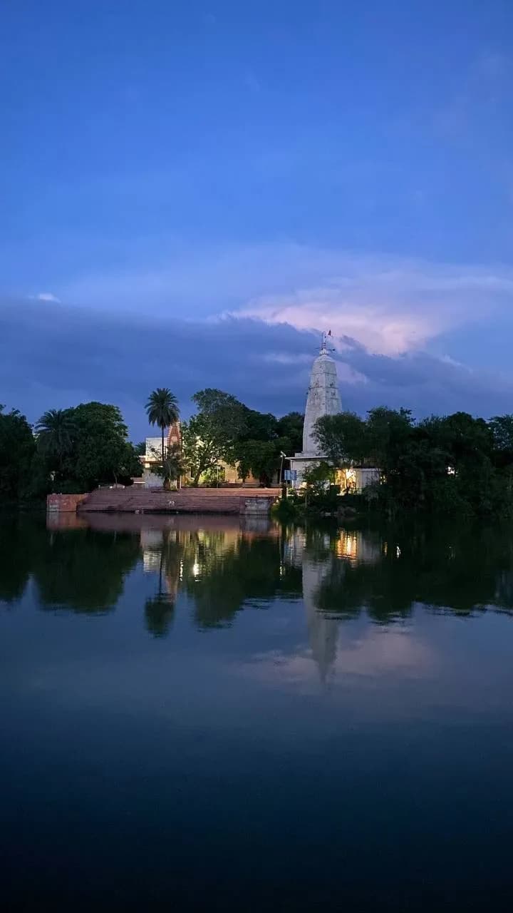 Man-sarovara at sunset: the temple reflected in still water